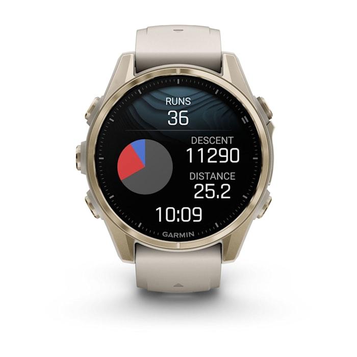 Fēnix® 8 - 43 mm, AMOLED, Sapphire, Soft Gold con cinturino Fog grey/dark sandstone in silicone