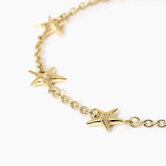 Bracciale dorato con ciondoli stella marina