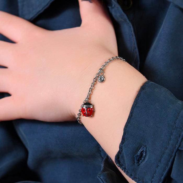 BRACELET FILLE EN ACIER AVEC COCCINELLE AVEC ÉMAIL ROUGE ET NOIR ET CRISTAL