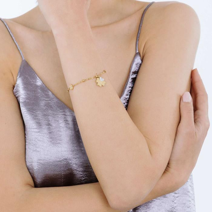 Bracelet en acier doré IP avec trèfles à quatre feuilles et cristaux blancs