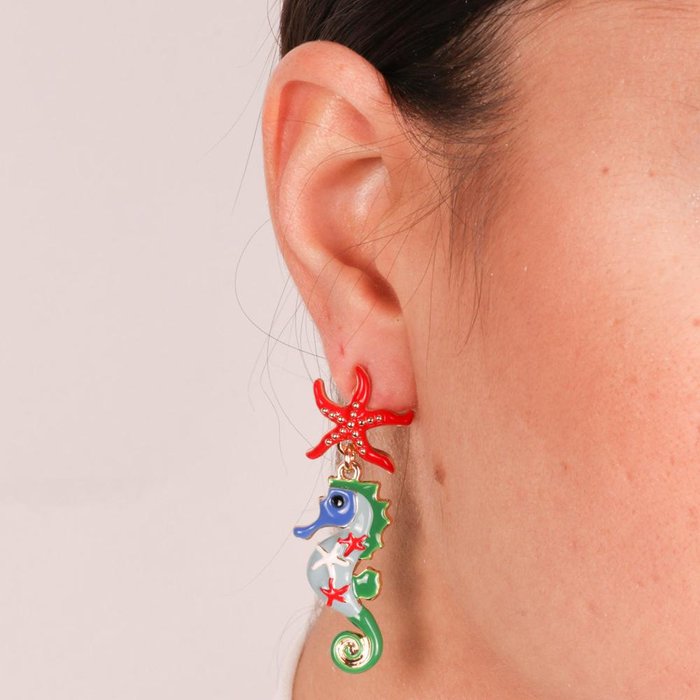 Metal earrings with hanging seahorse