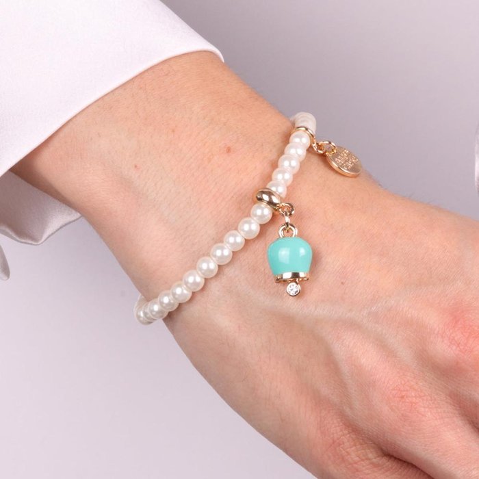 Metal bracelet with pearls and green enamel lucky bell