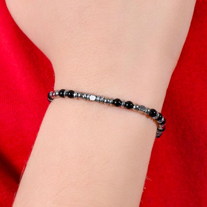 BRACCIALE BAMBINO IN ACCIAIO CON PIETRE NERE E GRIGIE