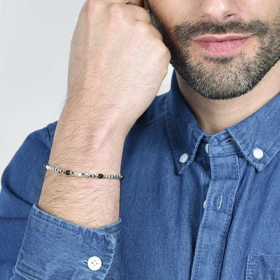 BRACCIALE UOMO IN ACCIAIO CON PIETRE NERE ED ELEMENTI IP GOLD