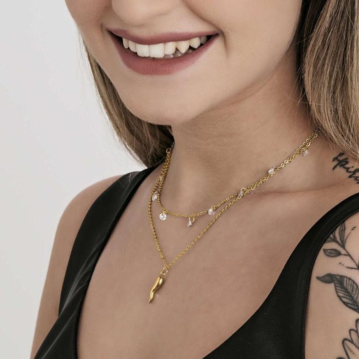 Collana in acciaio ip gold con corno e cristalli